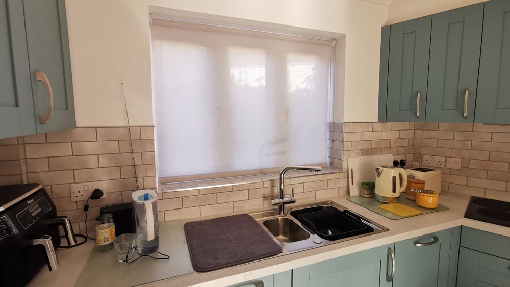 kitchen blind blog x Semi translucent roller blind above kitchen sink